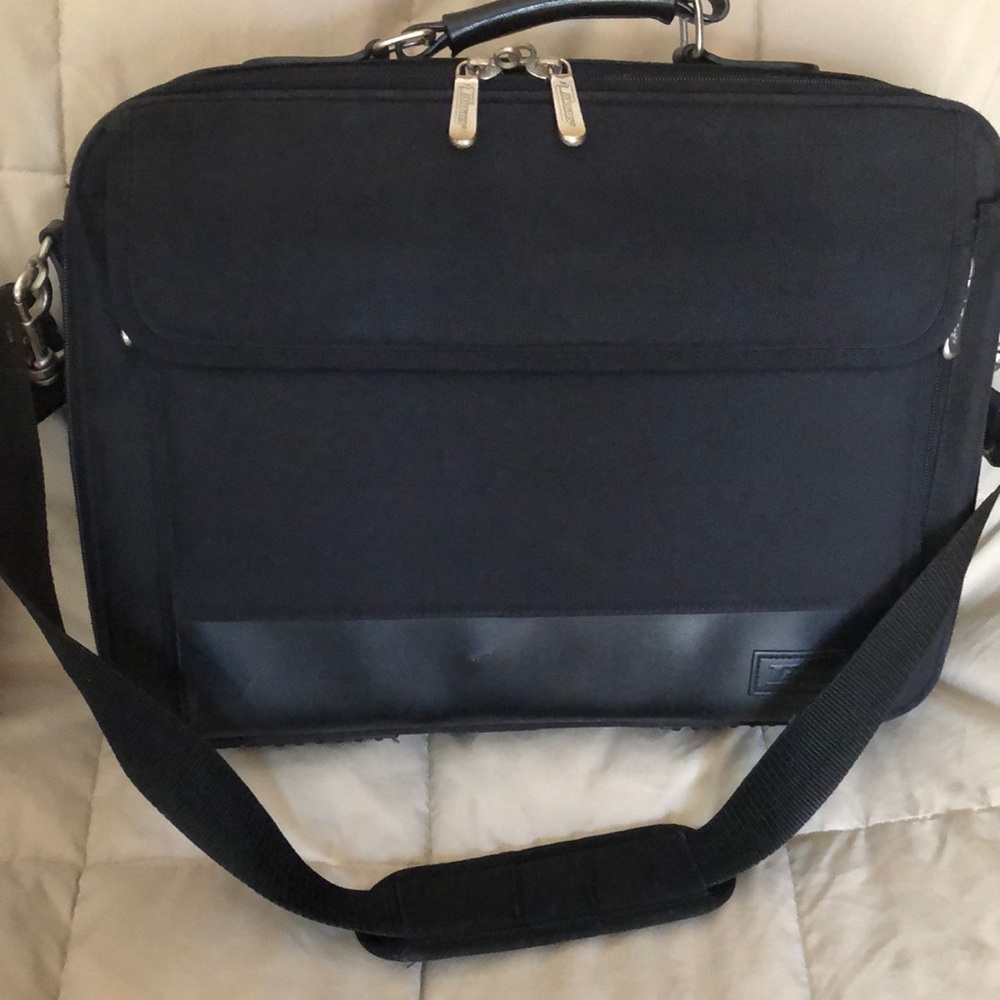 Black brief case/computer bag with several compartments. Good shape. Mild wear.